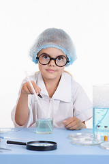 Image showing Chemist pours reagent liquid in the flask