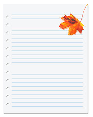 Image showing Notebook paper with orange autumn maple leaf on white