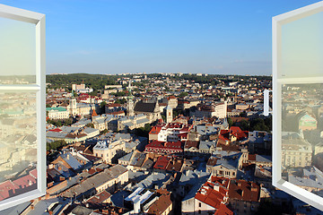 Image showing opened window to the roofs of city