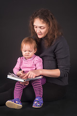 Image showing Pretty mother with daughter reading book