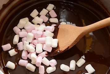 Image showing Stirring mini marshmallows into melted chocolate