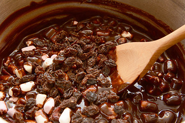 Image showing Mixing raisins, marshmallows and melted chocolate