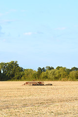 Image showing Harrow among the stubble on harvested farmland