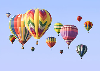 Image showing A group of colorful hot-air balloons floating