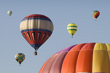 Image showing Hot-air Balloons Floating in a Blue Sky