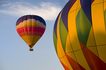 Image showing Airborne hot-air balloon with another in foreground