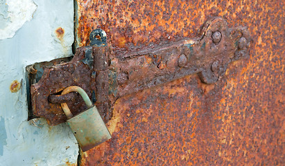 Image showing Rusted Locked Solid Metal Door Hinge Padlock