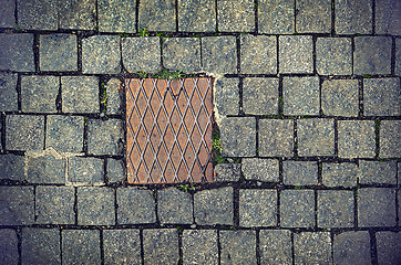 Image showing Paving stones background with metal plate