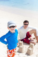 Image showing family building sand castle