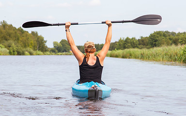 Image showing Woman on a small river in rural landscape