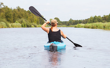 Image showing Woman on a small river in rural landscape