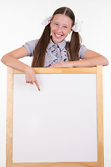 Image showing Teen Girl points a finger at promotional booth