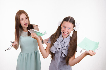 Image showing Trainee tears notebook in front of the teacher