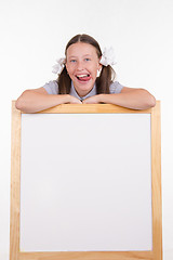 Image showing Girl shows tongue advertising stand