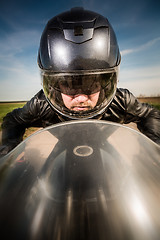 Image showing Biker racing on the road