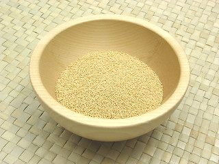 Image showing Wooden bowl with amaranth on rattan underlay