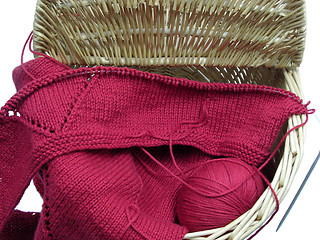 Image showing Red knitting with whole pattern in a wooden basket
