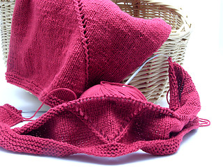 Image showing Red knitting with whole pattern in a wooden basket