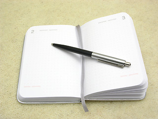 Image showing To flip an appointment calendar open with ball pen