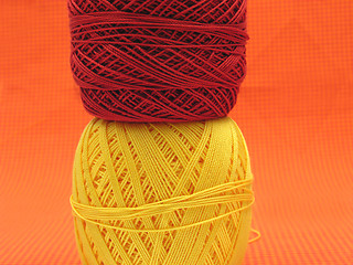 Image showing Two balls of wool  on a checked background