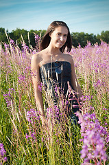 Image showing Beautiful girl on the flowers field