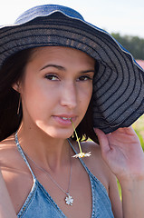 Image showing Woman with chamomile in mouth