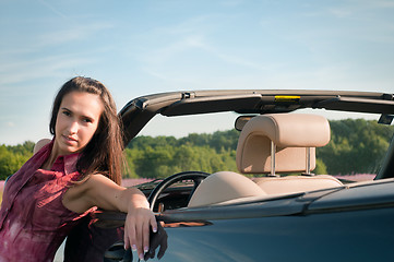 Image showing Young woman recline on the car