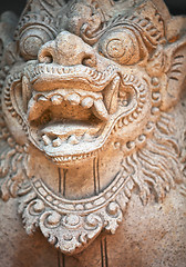 Image showing Muzzle of terrible mythical monster. Stone statue from Indonesia