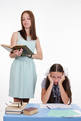 Image showing Schoolgirl sitting on a boring lesson