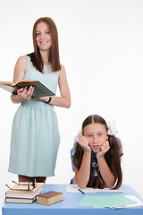 Image showing Schoolgirl tired to learn a lesson