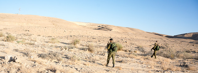 Image showing Soldiers patrol in desert