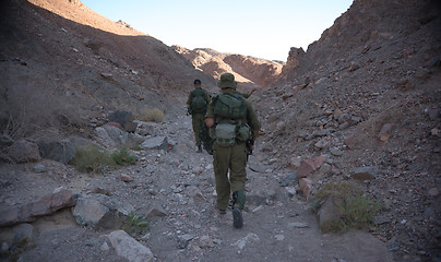 Image showing Soldiers patrol in desert