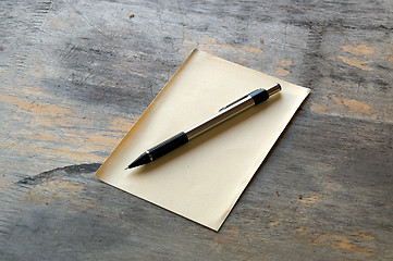 Image showing pencil and paper on wood