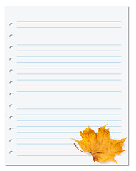 Image showing Notebook paper with autumn dry maple leaf on white