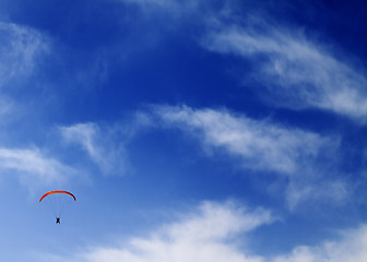 Image showing Silhouette of skydiver at sky