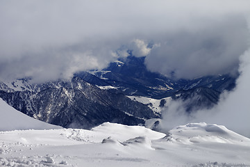 Image showing Winter snowy mountains in clouds