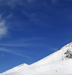 Image showing Winter snowy mountains and ski slope