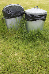 Image showing waste bins in grass
