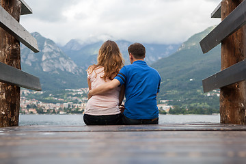 Image showing Young couple on the pier looking on Como lake