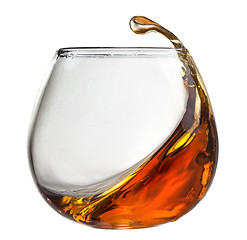 Image showing Splash of cognac in glass isolated on white