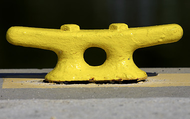 Image showing Yellow mooring post