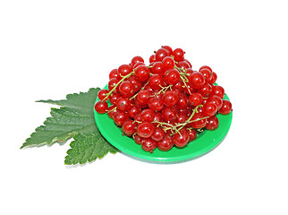 Image showing Red currant on small plates decorated with leaves isolated