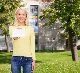 Image showing smiling girl with blank business or name card