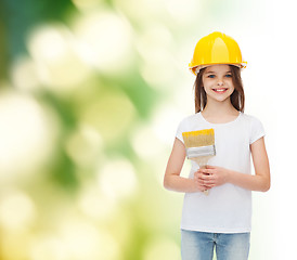 Image showing smiling little girl in helmet with paint brush