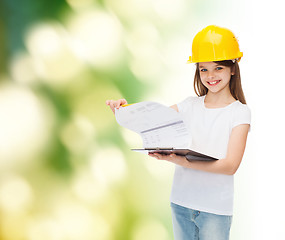 Image showing smiling little girl in hardhat with clipboard