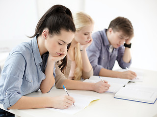 Image showing tired students with notebooks at school