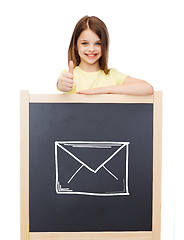 Image showing smiling girl with blackboard showing thumbs up