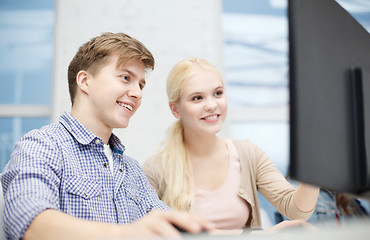 Image showing smiling teenage boy and girl in computer class