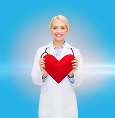 Image showing smiling female doctor with heart and stethoscope