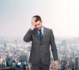 Image showing handsome businessman having headache